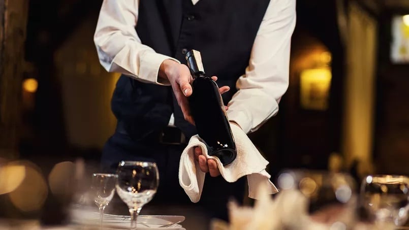 Table-etiquette-presentation-of-bottle-of-wine-by-a-waiter